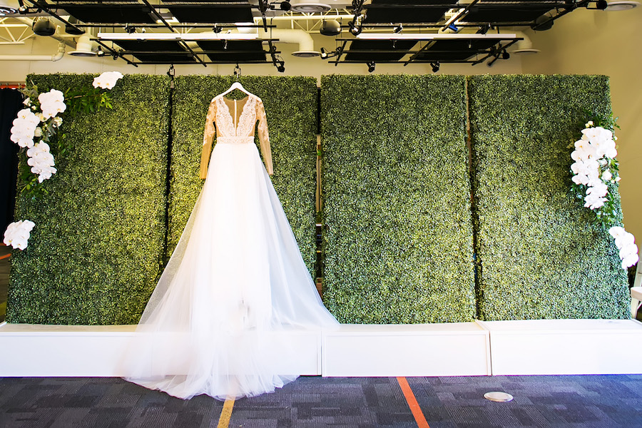 Nude Illusion Lace Wedding Dress with Sleeves and Greenery Hedge Backdrop Wall | Tampa Bay Bridal Shop Isabel O'Neil Bridal | Rental and Decor Company A Chair Affair | Wedding Photographer Limelight Photography