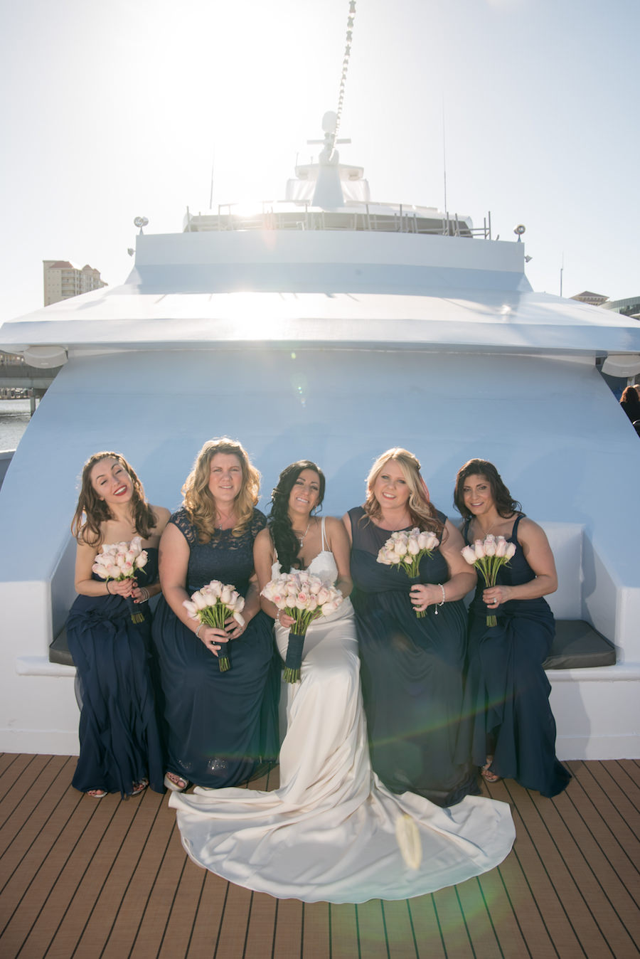Tampa Bridal Party Wedding Portrait in Navy Bridesmaids Dresses with Ivory Rose Wedding Bouquet and Bride in Ivory Satin Wedding Dress on The Yacht Starship II