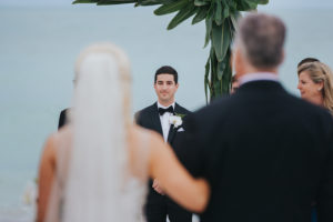 Outdoor Sarasota Wedding Ceremony Groom Looking at Bride Walking Down Aisle