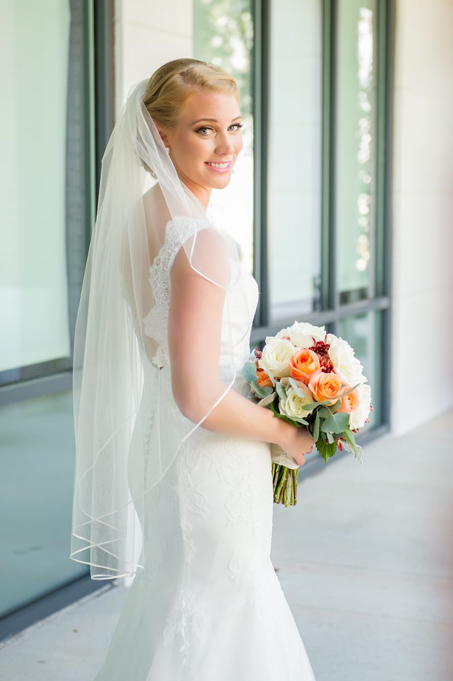 Bridal Wedding Portrait in Open Back Lace Wedding Dress with Wedding Bouquet of Ivory, Orange and Red Flowers | Tampa Bay Wedding Photography Andi Diamond Photography