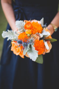 Fall Inspired Bridesmaids Wedding Bouquet with Orange Flowers and Greenery | Navy Blue Bridesmaids Dress with Bouquet