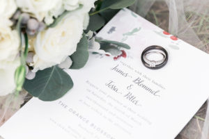 White Floral Garden Invitation with Black Wedding Groom's Wedding Band and Round Cut Diamond Engagement Ring