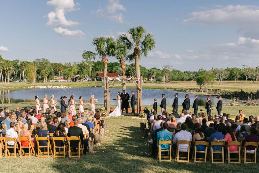Blush Pink Rustic Lakefront Wedding Ceremony with Bride and Groom at Altar with Bridal Party | Tampa Bay Wedding Videographer Hatfield Productions