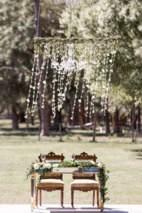 Outdoor Rustic Wedding Reception Sweetheart Table with Greenery Chandelier | Sarasota Wedding Planner Jennifer Matteo Event Planning