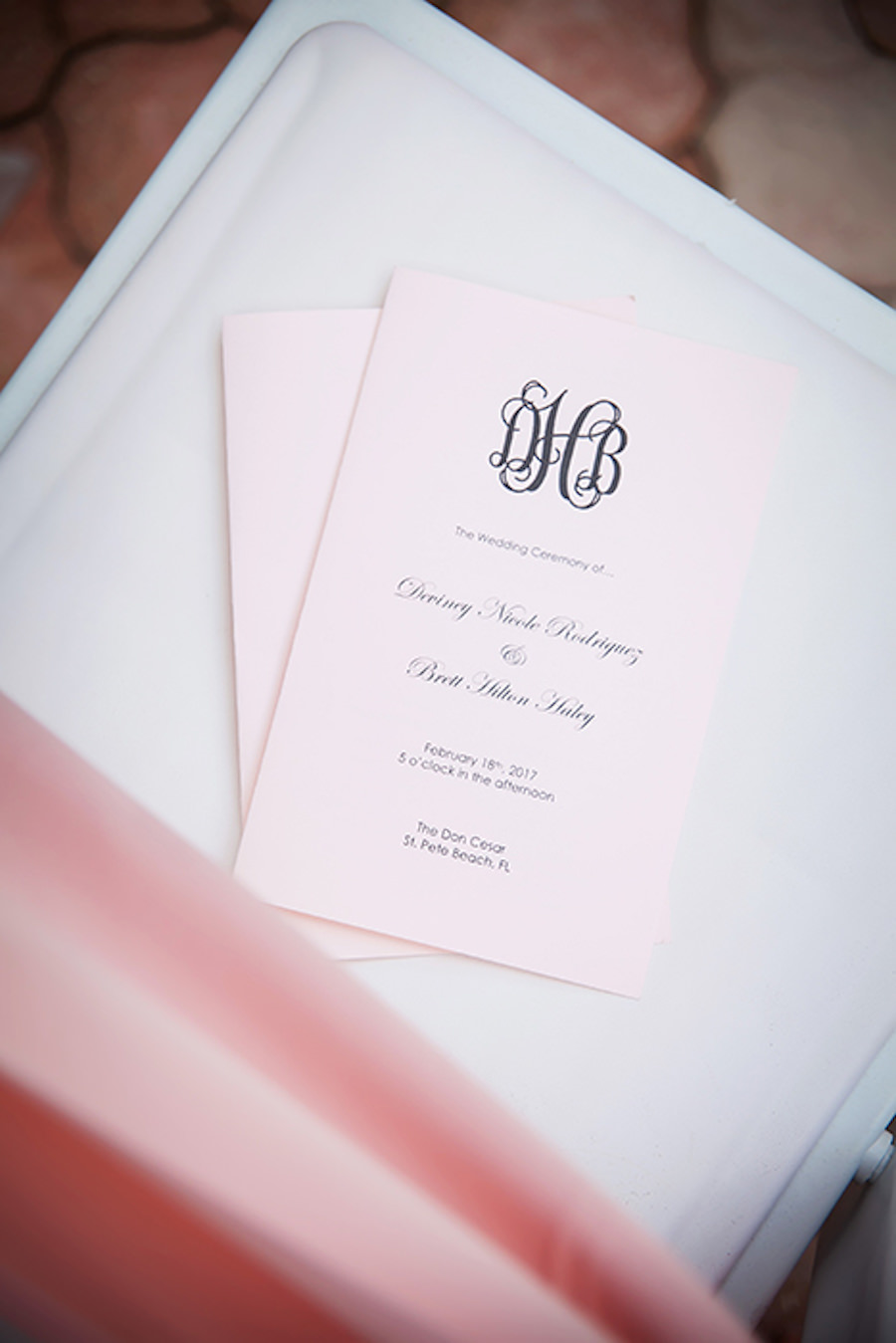 Elegant and Classic Wedding Day Programs On Light Pink Paper with Grey Monogram by Invitation Galleria Tampa FL