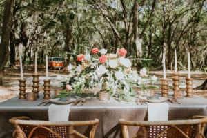 Peach and Blush Pink Wedding Centerpieces with Greenery, Candles and Wicker Chairs | Retro Vintage Boho Wedding Inspiration | Tampa Wedding Florist Northside Florist | Planner Glitz Events | Outdoor Venue Casa Lantana