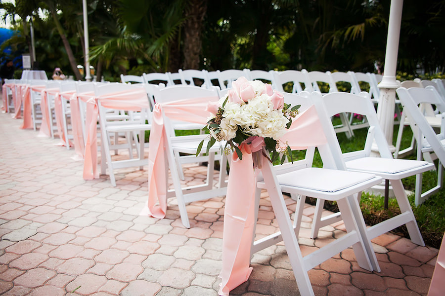 Outdoor Wedding Ceremony with Ivory Hydrangea and Blush Pink Aisle Decor on White Resin Folding Chairs | St Petersburg Wedding Venue The Don Cesar | St Petersburg Wedding Photographer Limelight Photography