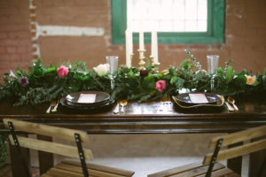 Florida, Modern Bohemian Inspired Styled Shoot | Vintaged Wooden Sweetheart Table with Folding Chairs and Greenery Garland Decor and Gold Flatware and Charger Plates | Tampa Bay Wedding Planner Glitz Events