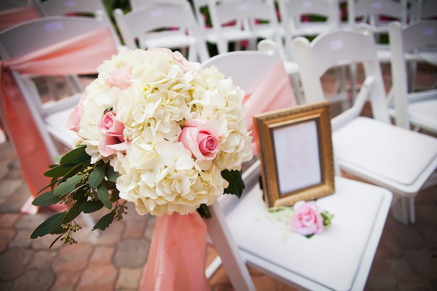Ivory Hydrangea and Light Pink Rose Outdoor Wedding Ceremony Aisle Decor on White Resin Folding Chairs | St Petersburg Wedding Venue The Don Cesar | St Petersburg Wedding Photographer Limelight Photography