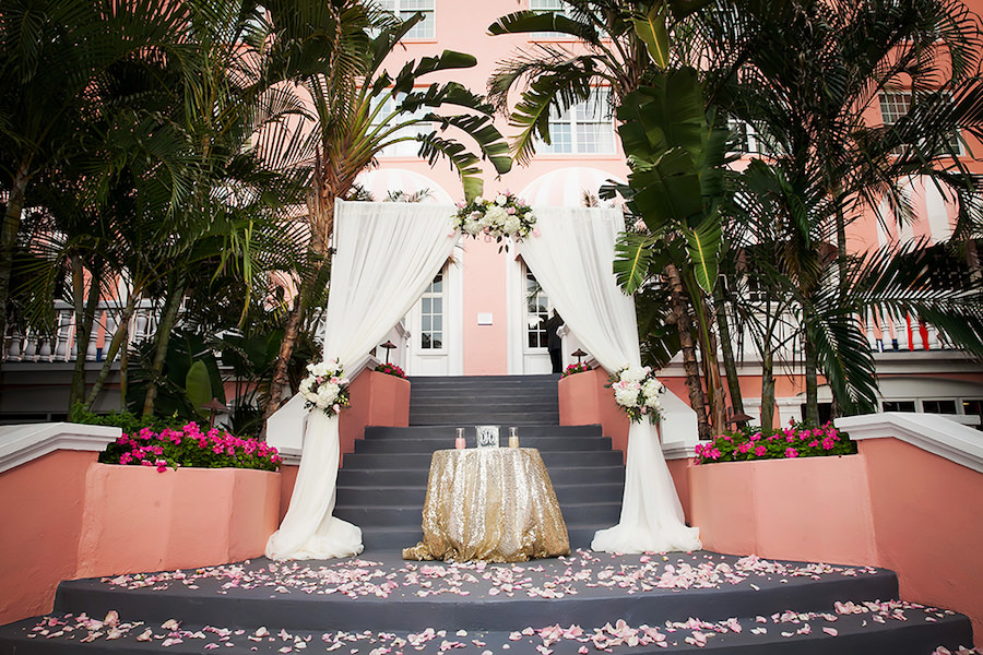 St Petersburg Outdoor Wedding Ceremony with White Tulle Wedding Arch and Light Pink and Ivory Rose Floral Arrangements at Wedding Venue The Don Cesar | St Pete Beach Wedding Photographer Limelight Photography