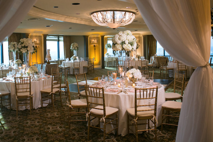 White and Gold Wedding Reception with Tall White Hydrangea Centerpieces and Gold Chiavari Chairs with White and Blush Linens | Rentals A Chair Affair | Linens by Gabro Event Services | Modern Elegant Downtown Tampa Wedding Venue The Tampa Club | Tampa Wedding Photographer Carrie Wildes Photography |Wedding Florist Northside Florist