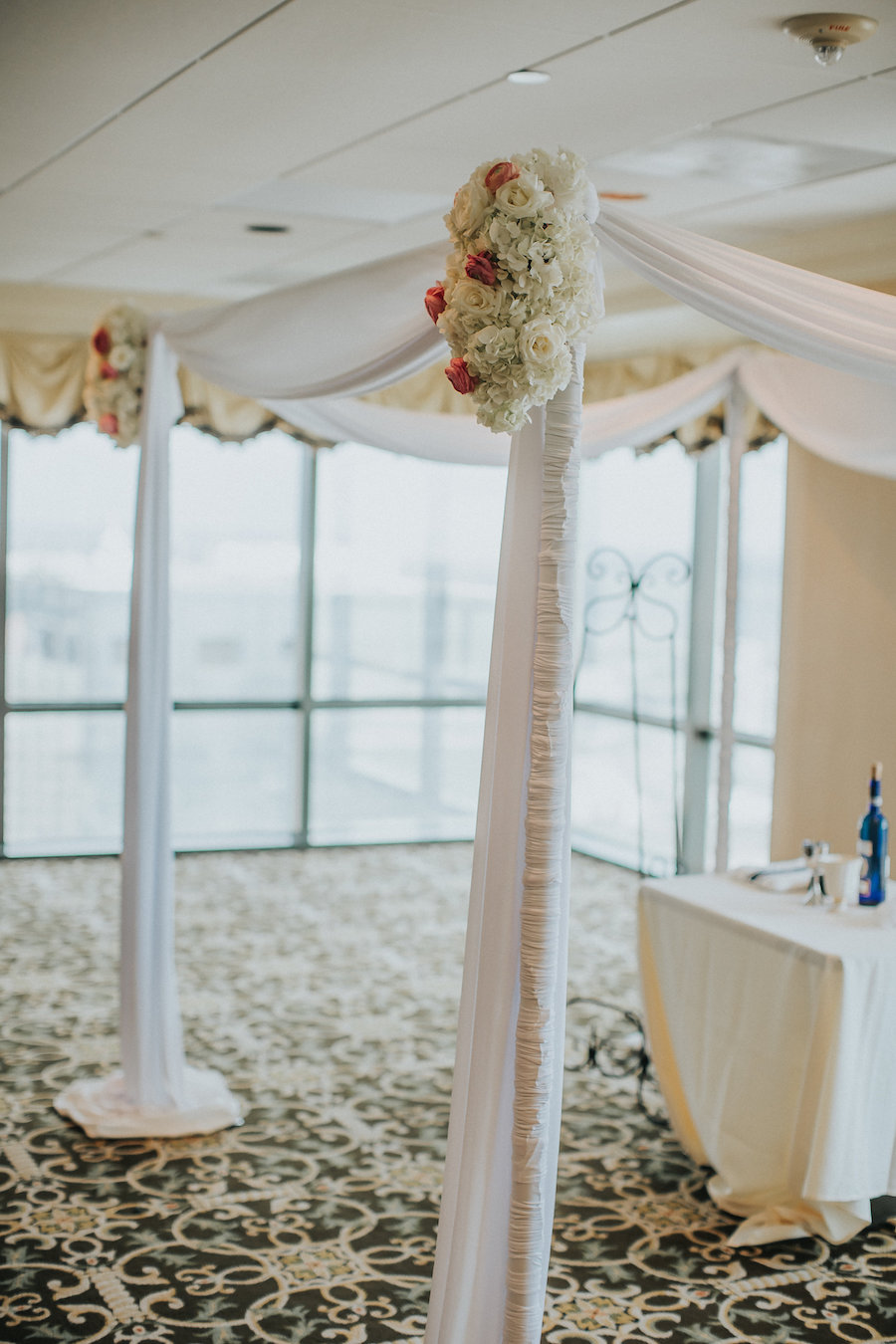 White Draped Ceremony Altar with Elegant Flowers and Decor | Downtown Tampa Wedding Venue The Tampa Club