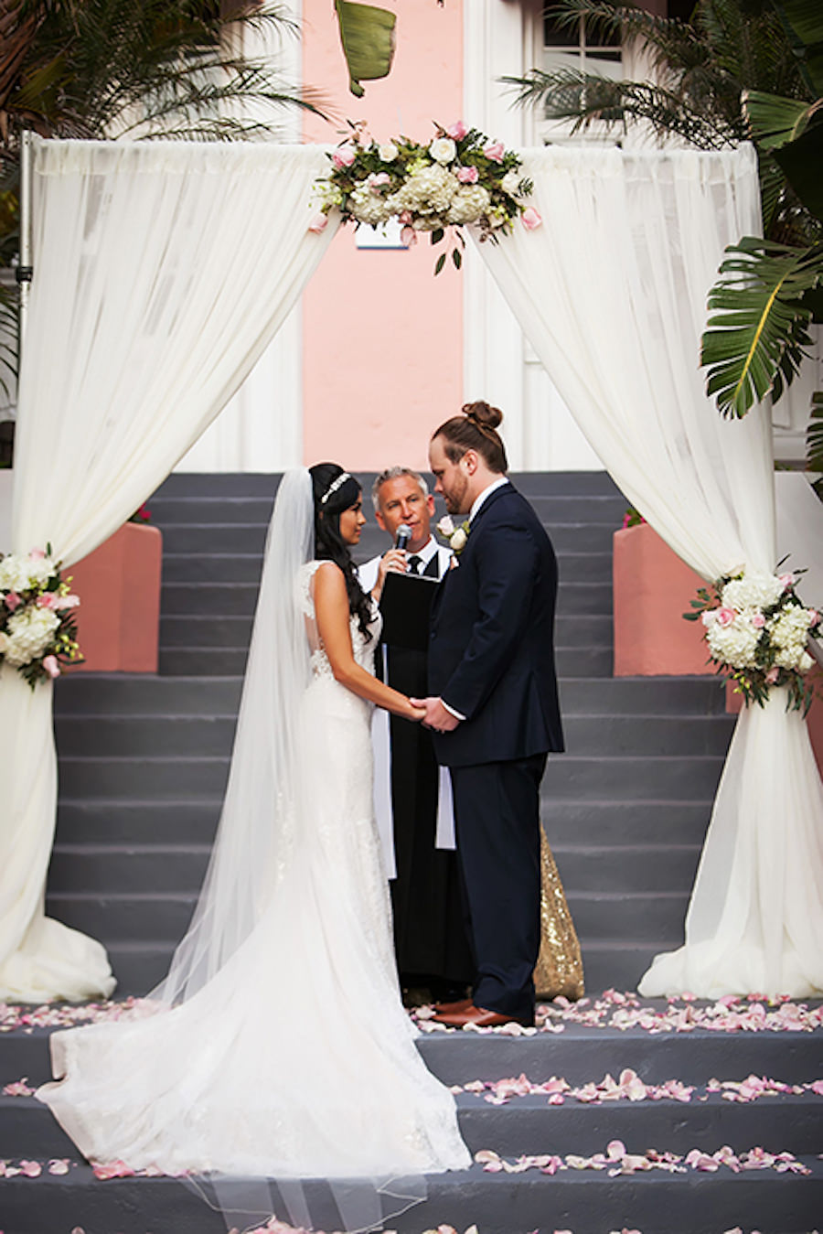 St Petersburg Outdoor Wedding Ceremony with White Tulle Wedding Arch and Light Pink Rose Petals at Wedding Venue The Don Cesar | St Petersburg Wedding Photographer Limelight Photography
