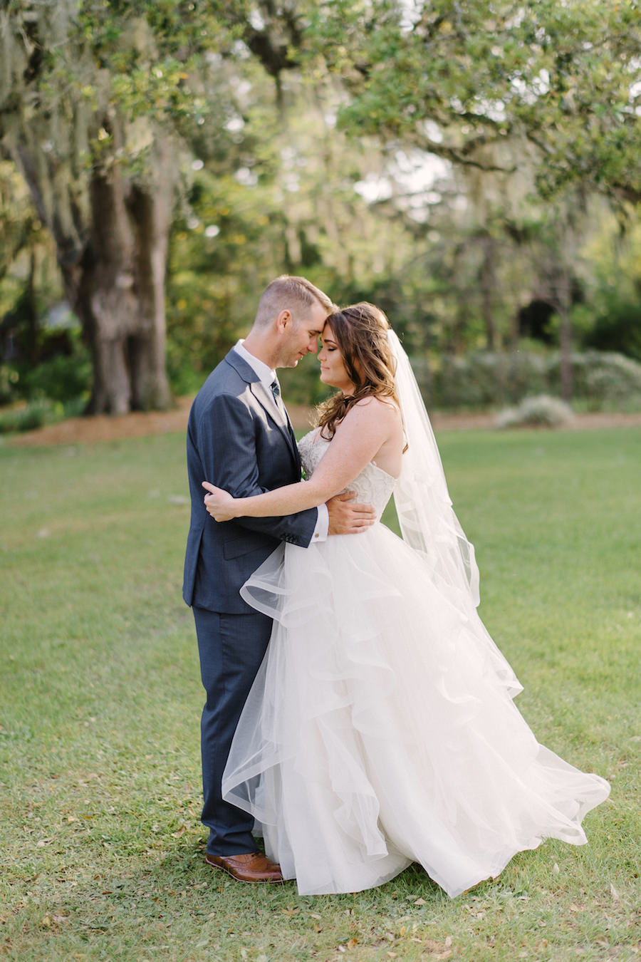 Tampa Bay Bride and Groom Wedding Day Portrait in White Essence of Australia Tulle Wedding Gown and Navy Blue Suit