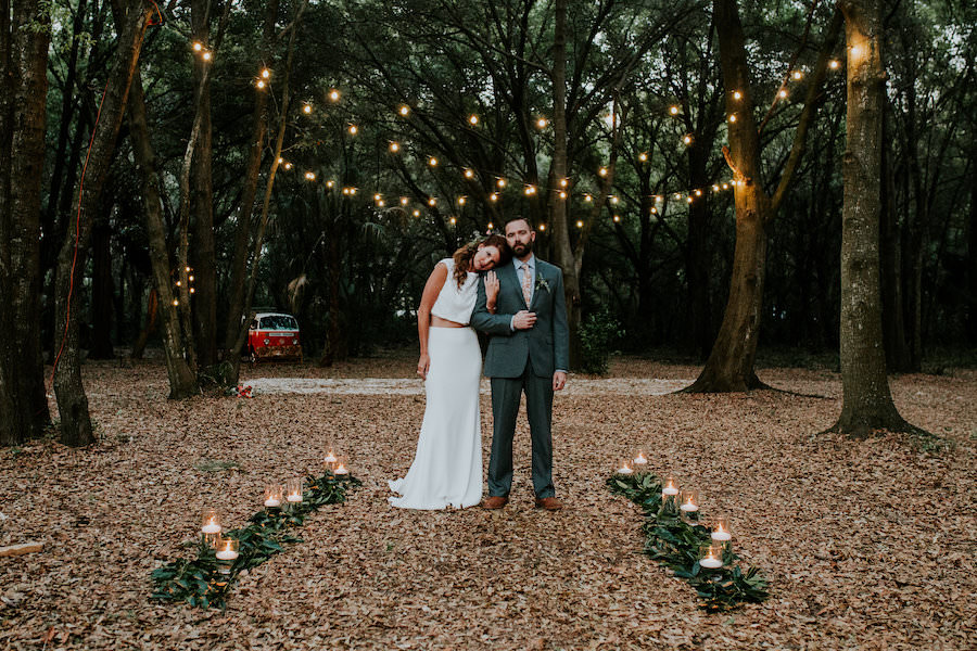 Bride and Groom Wedding Portrait with in Forest with Market String Lights | Retro Vintage Boho Wedding Inspiration | Planner Glitz Events | Outdoor Venue Casa Lantana | Lighting by Gabro Event Services