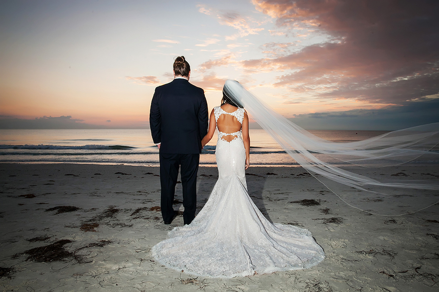 St Pete Bride and Groom Beach Sunset Wedding Portrait with Backless Lace Mermaid Wedding Gown and Cathedral Veil | St Petersburg FL Wedding Photographer Limelight Photography