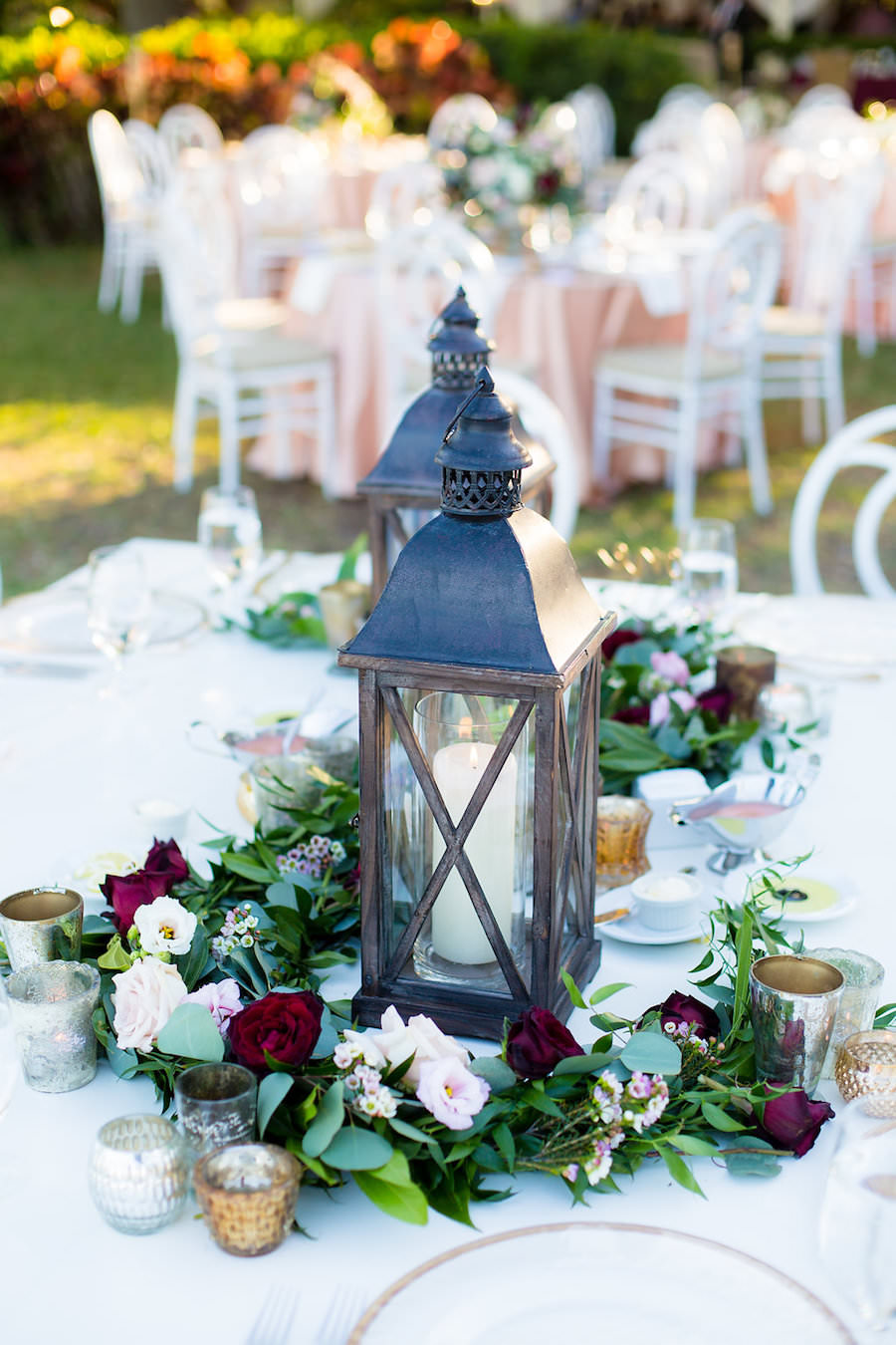Rustic Wedding Centerpiece with Lantern and Candle Surrounded by Wreath of Ivory and Merlot Roses and Greenery | Tampa Wedding Photographer Kera Photography