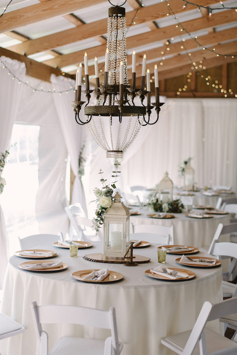 Rustic Ranch Wedding with White Linens, Rustic Brass Chandeliers and Twinkle Lights at Tampa Bay Rustic Wedding Venue Cross Creek Ranch
