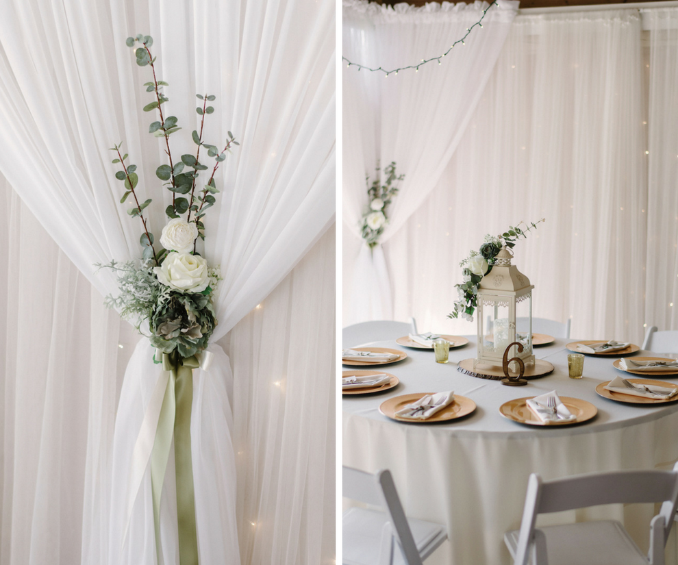 White and Hunter Green Rustic Wedding Decor | White Lanterns and Wooden Table Numbers on White Linens with Ivory Roses and Eucalyptus Wedding Centerpieces