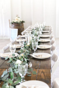 Long Feasting Table with Garland Greenery Centerpieces and Wooden Farm Tables | | Rustic, Country Wedding Reception Decor Inspiration | Florist Cotton & Magnolia