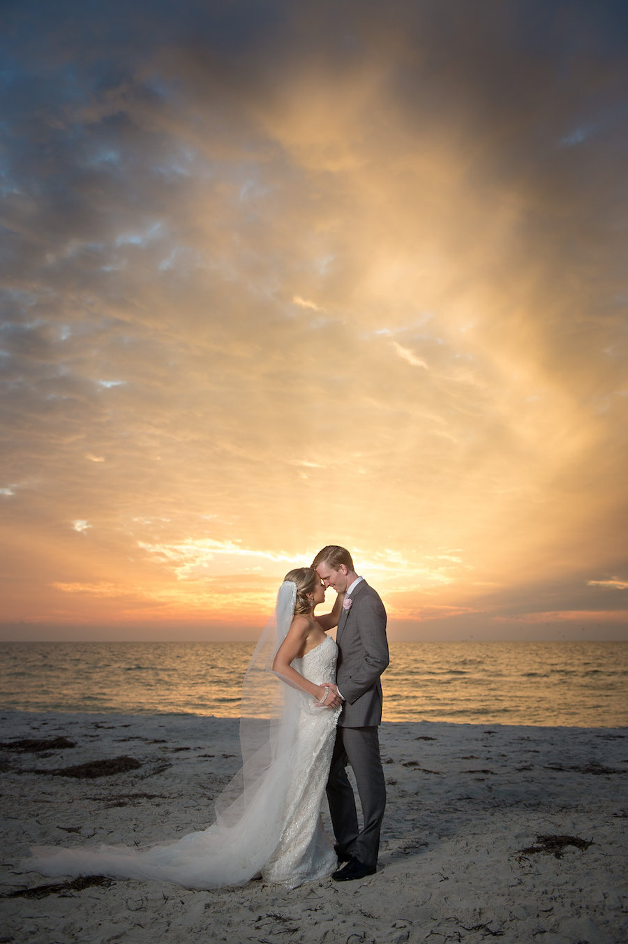 Bride and Groom Clearwater Beach Sunset Wedding Portrait in the Sand | Clearwater Beach Wedding Planner Parties a la Carte | Photographer Marc Edwards Photographs