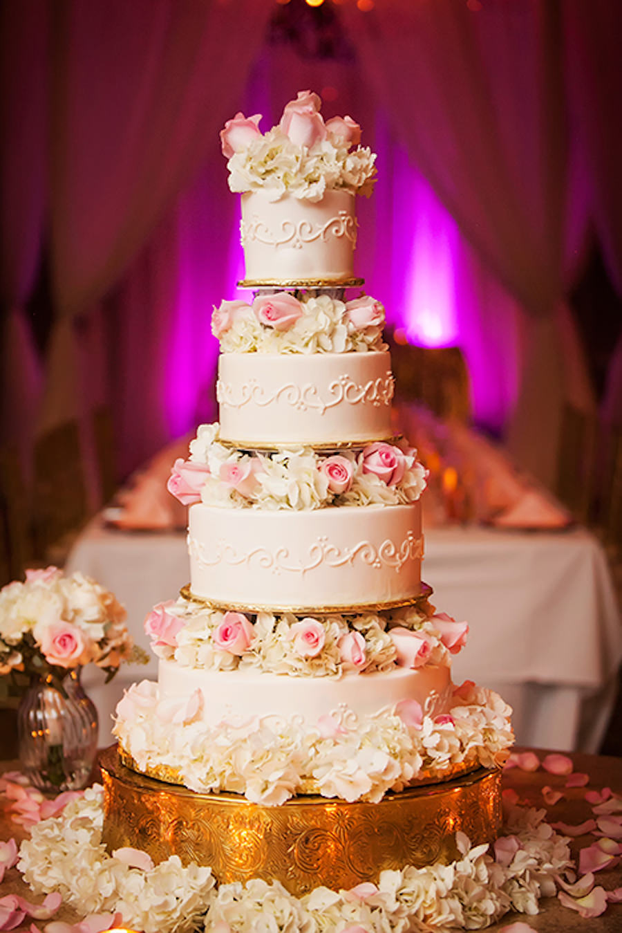 Four Tier Round Ivory Wedding Cake with Light Pink Roses and Ivory Hydrangeas on Gold Ornate Cake Stand | St Pete Wedding Photographer Limelight Photography