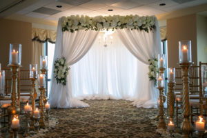 Wedding Ceremony: White Linen Arch with Ivory Florals and Chandelier | Tampa Bay Photographer Carrie Wildes Photography | Modern Elegant Downtown Tampa Wedding Venue The Tampa Club | Lighting and Linens Gabro Event Services | Wedding Florist Northside Florist