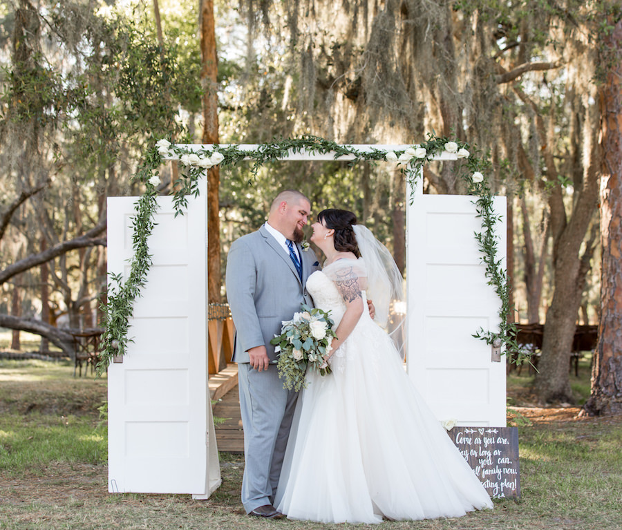 Outdoor Sarasota Bride and Groom Wedding Portrait with Rustic Barn Door Ceremony Decor | Sarasota Wedding Planner Jennifer Matteo Event Planning
