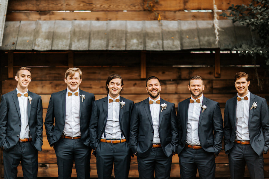 Groom and Groomsmen Wedding Party Portrait in Navy Suit with Wooden Bow Tie and White Boutonnière