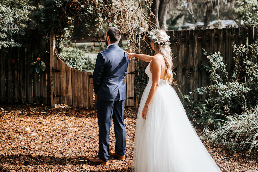 Florida Bride and Groom Outdoor First Look Wedding Portrait in Tulle Halter Wedding Dress Ball Gown | Rustic Florida Wedding Venue Cross Creek Ranch