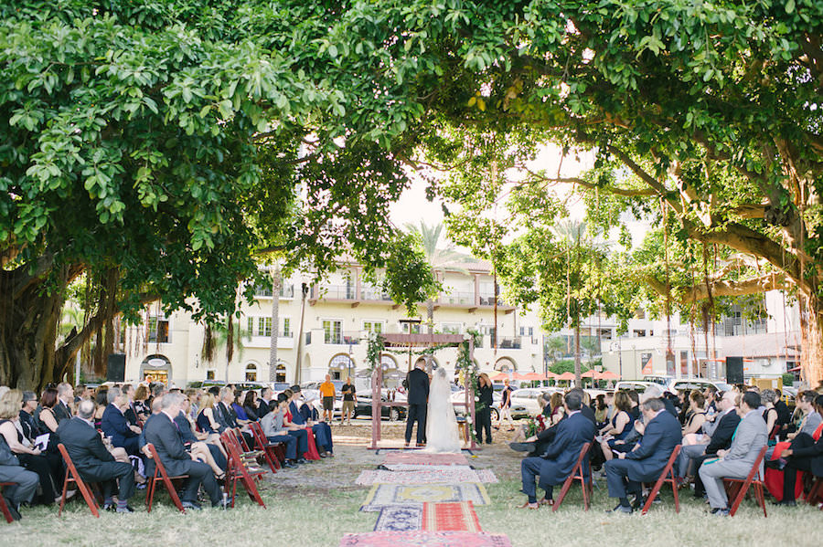 Bride and Groom Wedding Ceremony Portrait | Outdoor Florida Jewish Wedding Ceremony in Downtown St. Pete under Oak Trees with Wooden Folding Chairs and Chuppah