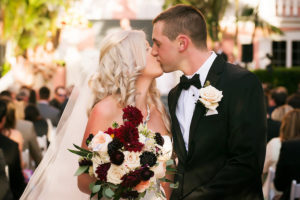 Bride and Groom Wedding Ceremony First Kiss Portrait with Burgundy and Pink Bridal Bouquet | St Pete Wedding Photographer Limelight Photography