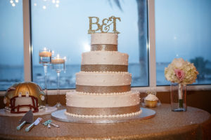 Four Tier Round Wedding Cake with Glitter Ribbon and Initial Cake Topper on Sequined Linen