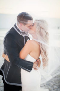 St Pete Beach Bride and Groom Wedding Kissing Portrait Under Veil | Don CeSar Wedding | St Pete Wedding Photographer Limelight Photography