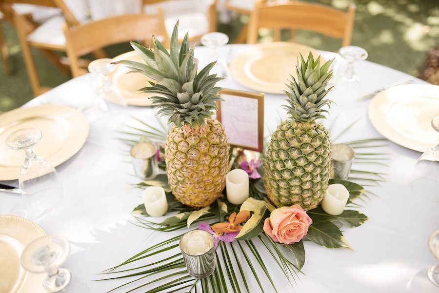 Tropical Pineapple Hawaiian Inspired Wedding Centerpiece with Gold Chargers and Palm Leaves | Wedding Reception Decor and Inspiration | St. Petersburg Wedding Florist Wonderland Floral Art | St. Pete Beach Photographer Kristin Marie Photography
