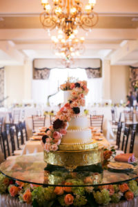 Four Tiered Round Ombre Wedding Cake with Fresh Rose Garland Accent Over Cake Table with Floral Decor in Don CeSar Hotel Ballroom | Limelight Photography