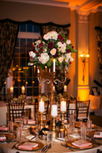 Burgundy and Gold Don CeSar Hotel, St Pete Florida Wedding Reception with Brown Chiavari Chairs with Gold Candelabras and Tall Floral Centerpieces with Candlesticks | Limelight Photography