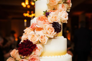 Four Tiered Round Ombre Wedding Cake with Fresh Pink and Red Rose Garland | Limelight Photography