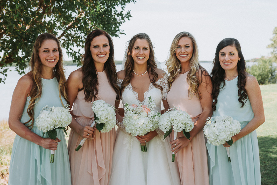 Pastel Bridesmaids Dresses with Bride in White Wedding Dress with Lace Low Cut Wedding Dress with White Floral Bouquets | St. Pete Wedding Photographer Grind and Press Photography