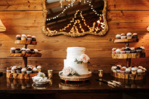 Rustic, Inspired Wedding Dessert Bar with Two Tier White Ruffled Wedding Cake with Floral Accents and Cupcakes by Alessi Bakery