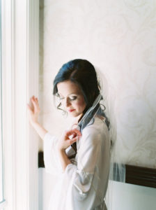 Bridal Getting Ready Wedding Portrait in White Silk Robe with Wedding Veil