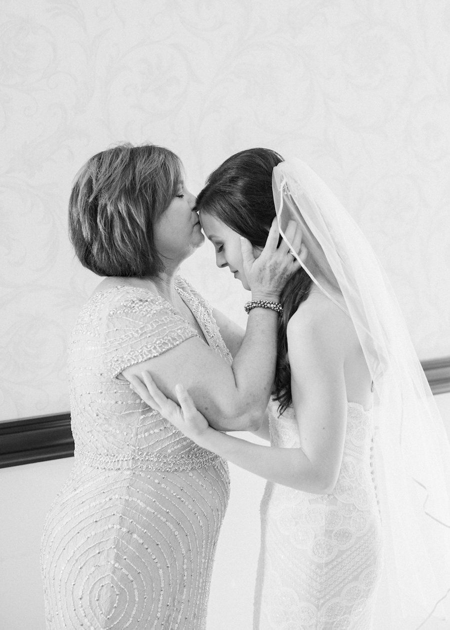 Bride and Mother of the Bride Kissing Daughter on Head Wedding Portrait
