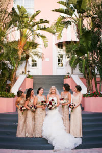 Florida Bridal Wedding Party Portrait at Don CeSar Hotel in St. Pete Beach | Ivory Strapless Drop Waist Pronovias Wedding Dress and Champagne, Gold Bridesmaids Dresses | Pronovias Wedding Dress | Tampa Wedding Photographer Limelight Photography