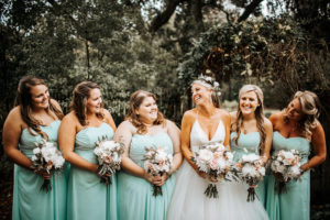 Bride and Bridesmaids Wedding Portrait in White Tulle Ballgown with Ivory and Greenery Bouquets and Bridal Floral Crown