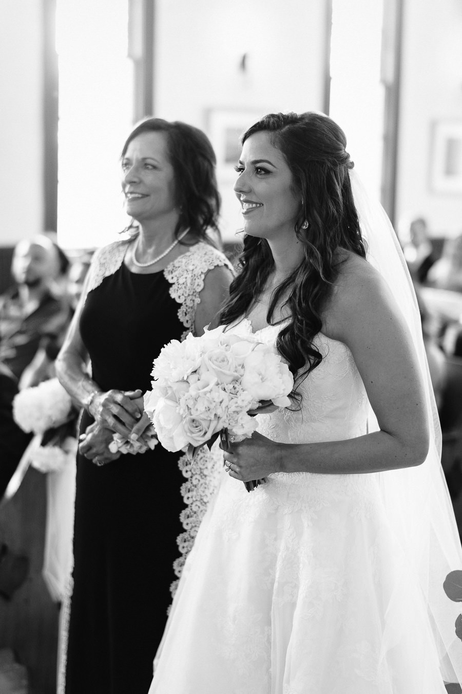 Bride and Mother Walking Down Aisle with White Rose Wedding Bouquet