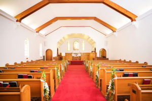 Tampa Bay Wedding Ceremony Venue Anona Methodist Church with Long White Floral with Greenery Aisle Decor