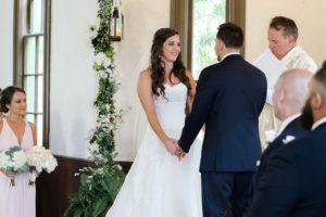 Traditional Wedding Ceremony Portrait with Watters Wedding Dress with Long Train, White Climbing Greenery, Ferns in Copper Basins, and Blush Bridesmaids Dress | | Tampa Bay Wedding Venue Church Andrews Memorial Chapel Dunedin Florida