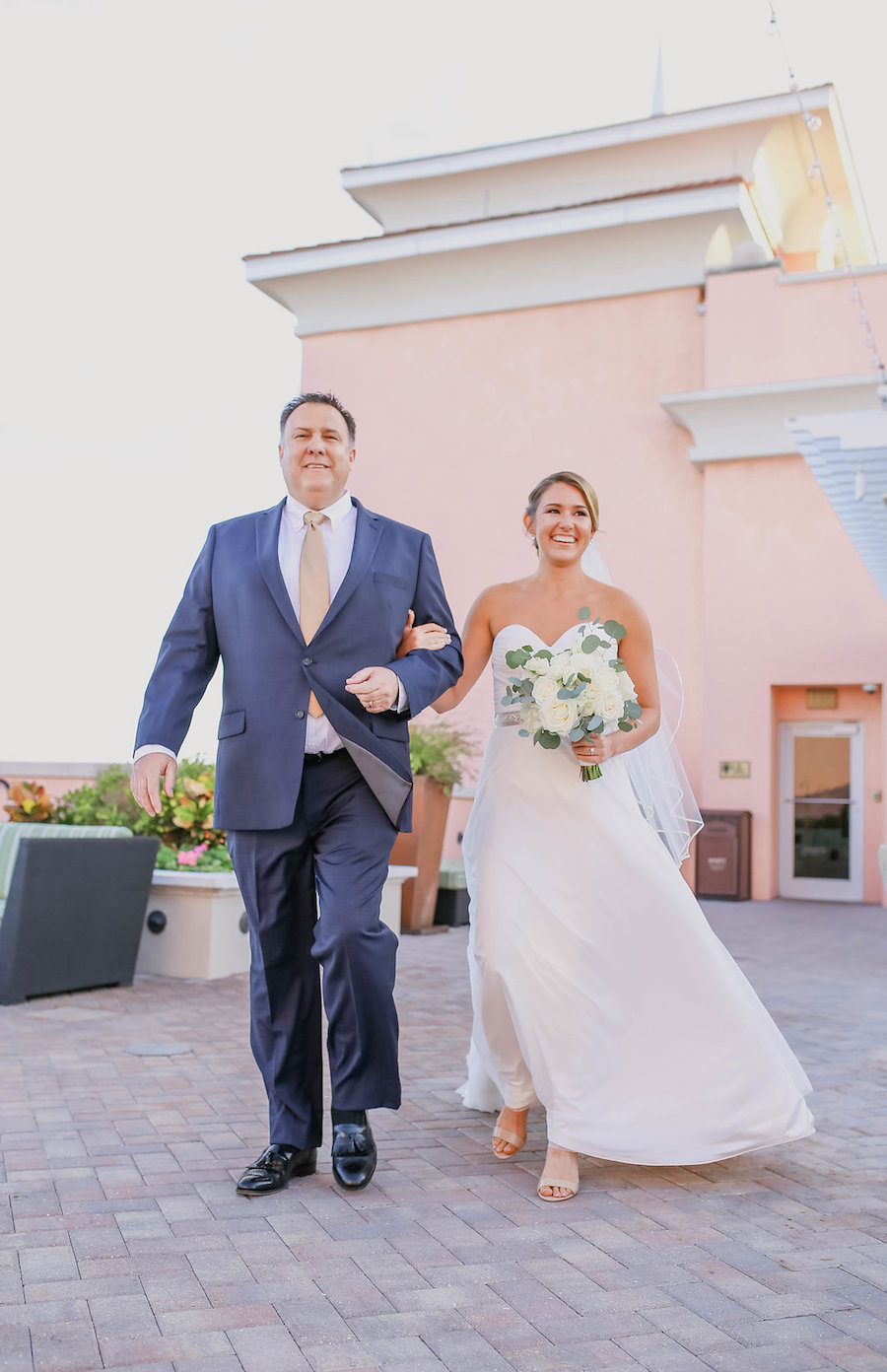 Bride and Father Wedding Ceremony Portrait wearing Sweetheart Mikaella by Paloma Blanca Dress with White Bouquet with Natural Greenery and Open Toed Sandals