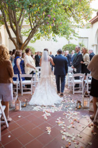Bride and Father Walking Down Rose Petal Strewn Aisle with White and Gold Candle Holders at Modern Elegant Blush Wedding | St. Petersburg Wedding Photographer Kristen Marie Photography | Wedding Venue Museum of Fine Arts St Pete