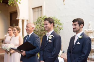 Groom's Reaction to Watching Bride Walk Down the Aisle | Ceremony Photo of Bridesmaids in Blush Alfred Sung Dresses and White and Blush Rose Bouquets and Boutonniere